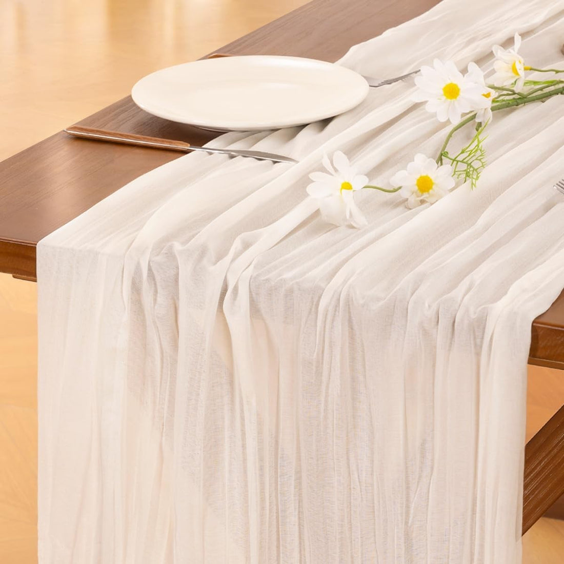 Socomi ivory cheesecloth table runner 120 by 35 inches draped on a rustic wooden table for boho wedding decor