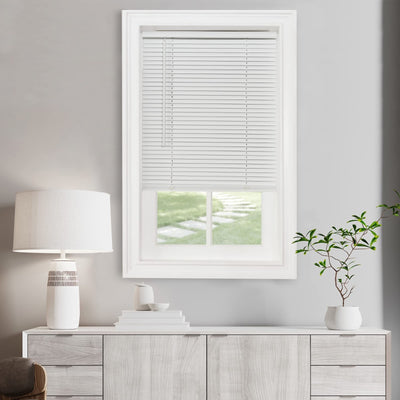 Achim pearl white vinyl cordless mini blind 40x64 inches installed on window with light filtering through slats