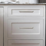 Five brushed nickel zinc alloy 7-inch cup pulls for kitchen cabinet drawers arranged on a white surface - view 4
