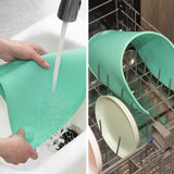 Teal oval silicone placemat 20x11 inches with raised edges and suction cups on a dining table surface - view 4