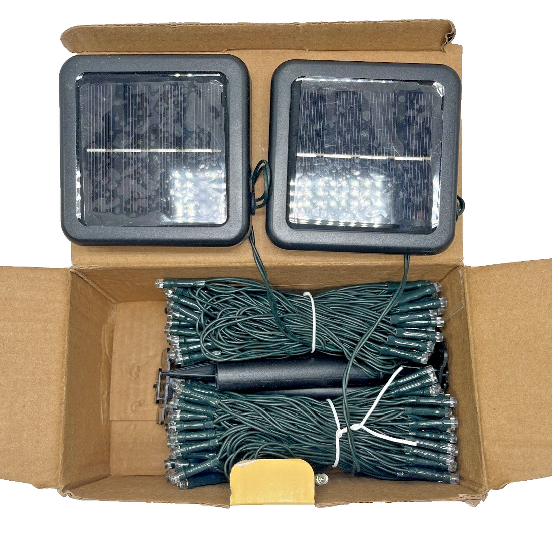 OZS 2-pack outdoor solar string lights with 240 cool white LEDs on green wire wrapped around garden fence and patio