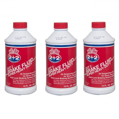 Three 12 fl oz jugs of Berkebile 2+2 DOT 3 Super Heavy Duty Brake Fluid model B1400 arranged together