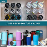 Clear plastic 3-tier stackable water bottle organizer holding 9 large tumblers on a kitchen countertop - view 3