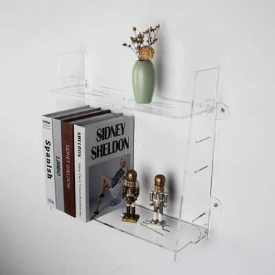 Two clear acrylic floating wall-mounted shelves 15 inches displayed in a bathroom holding small decor items