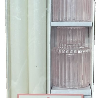 Two white 8-inch unscented taper candles standing in two translucent pink ribbed glass holders on a table