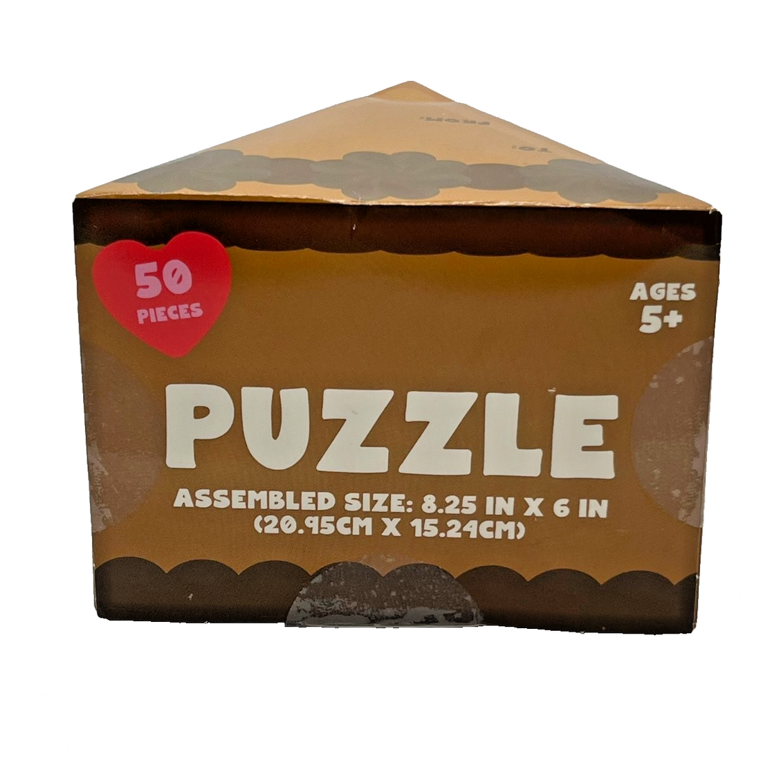 Wedge-shaped chocolate cake slice novelty gift box containing a 50-piece jigsaw puzzle with strawberry artwork