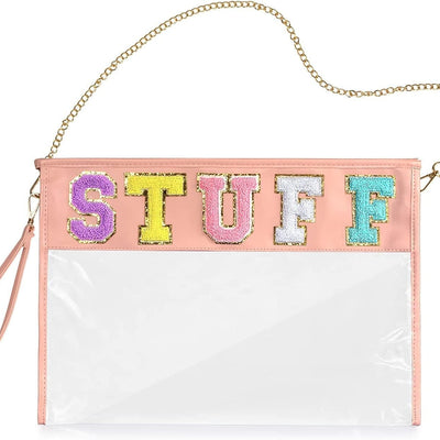 Clear transparent PVC makeup bag with pink chenille letter patch, gold zipper and wrist strap, shown as travel pouch