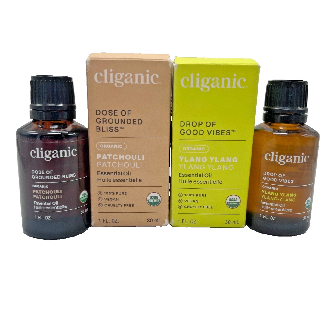 Two Cliganic 1 oz amber glass essential oil bottles with dropper inserts, patchouli and ylang ylang, in original boxes