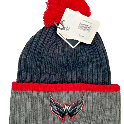 Black and grey ribbed knit Washington Capitals beanie with embroidered Weagle eagle logo on cuff and red pom-pom on top
