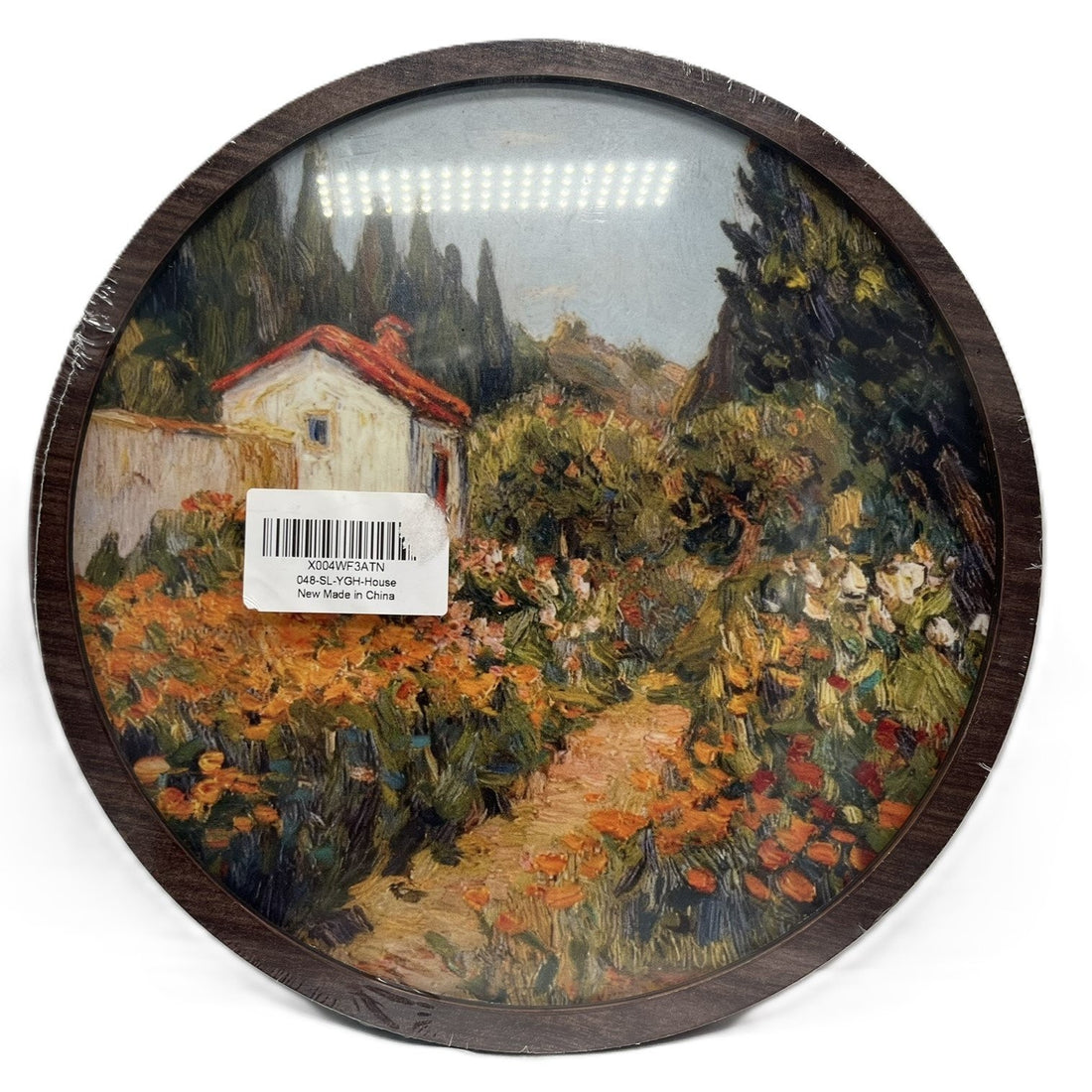 10 inch round dark walnut framed wall art featuring an Impressionist cottage garden landscape print with orange florals