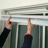 Classic Touch white vinyl cordless 1-inch mini blind 23x64 inches mounted on window with light filtering slats closed - view 2