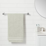 Threshold 24-inch polished chrome wall-mounted towel bar with curved design and concealed mounting hardware in bathroom - view 3