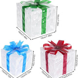 Three lit Christmas gift boxes in small, medium, and large sizes with red, green, and blue bows glowing with warm LED lights - view 2