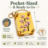 Blue metal mini flower press keychain kit shown with 20 specimen papers and 2 embossing plates, measuring 1.96x1.38 inches - view 2