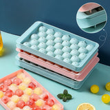 Two round sphere ice ball maker trays with lids in pink and blue BPA-free plastic for whiskey and cocktails - view 3