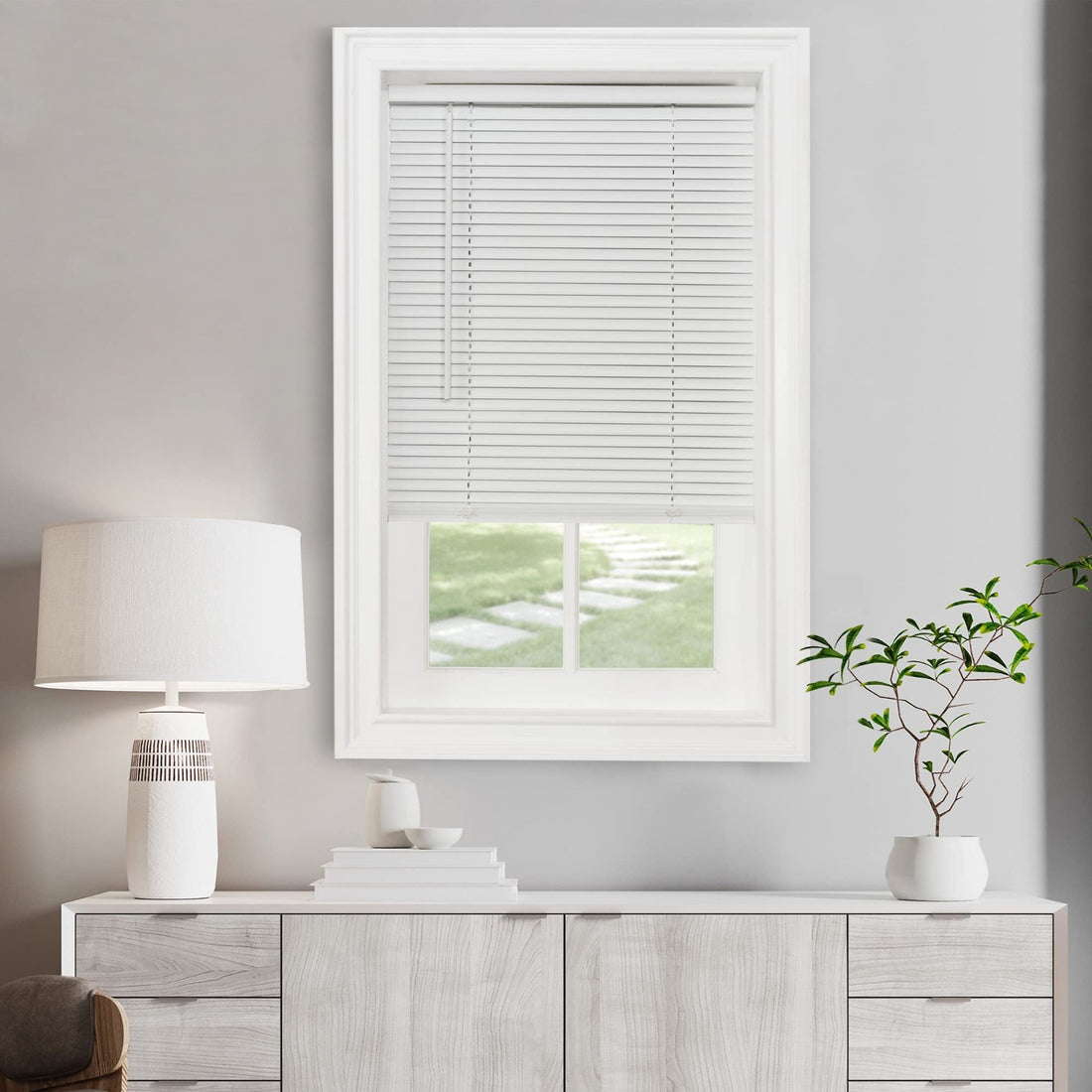 Achim Pearl White vinyl cordless mini blind 22x64 inches mounted inside window frame, filtering natural light