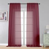 Pair of burgundy sheer voile rod pocket curtain panels 40x108 inches hanging on a window, LeCloud