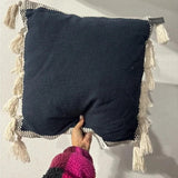 Threshold Studio McGee 20x20 inch navy blue throw pillow with cream woven border and side tassels on sofa - view 3