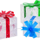Three lit Christmas gift boxes in small, medium, and large sizes with red, green, and blue bows glowing with warm LED lights - view 6