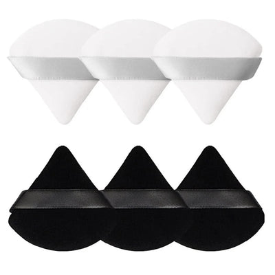 Six white and black triangle velour powder puffs with hand straps arranged in a set, for face contouring and powder application