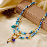 IQIC two-layer boho beaded necklace with cowrie shell and starfish charms, blue beads and gold-tone accents on white background - view 6