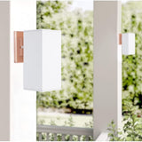 Cerdeco 9-inch outdoor wall sconce with rose gold metal base and white glass shade mounted on exterior wall - view 3