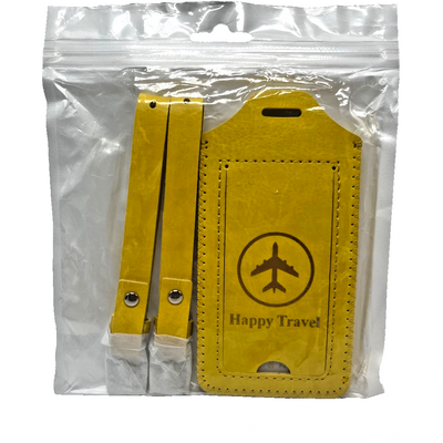 Two yellow leather luggage tags with privacy cover flap and airplane embossing, shown with adjustable snap attachment straps