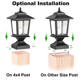 Two matte black solar post cap lights with glass shades mounted on 4x4 wood fence posts glowing warm white LED light - view 6