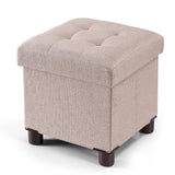 Small square khaki linen storage ottoman with wood legs and reversible lid, 12.6 inches, folded flat beside a living room sofa - view 2