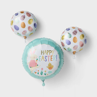Spritz 3-piece multicolor Easter foil helium balloons pre-filled and floating, shown as party decorations