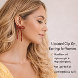 Silver bow-shaped clip-on dangle earrings with round clear CZ rhinestones on white background - view 4