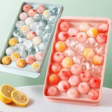 Two round sphere ice ball maker trays with lids in pink and blue BPA-free plastic for whiskey and cocktails - view 6