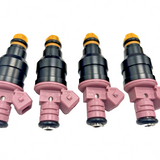 Set of 6 Bosch OEM cross-reference 0280150440 fuel injectors in mixed condition, including 4 new units, laid on surface - view 3