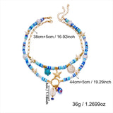 IQIC two-layer boho beaded necklace with cowrie shell and starfish charms, blue beads and gold-tone accents on white background - view 4