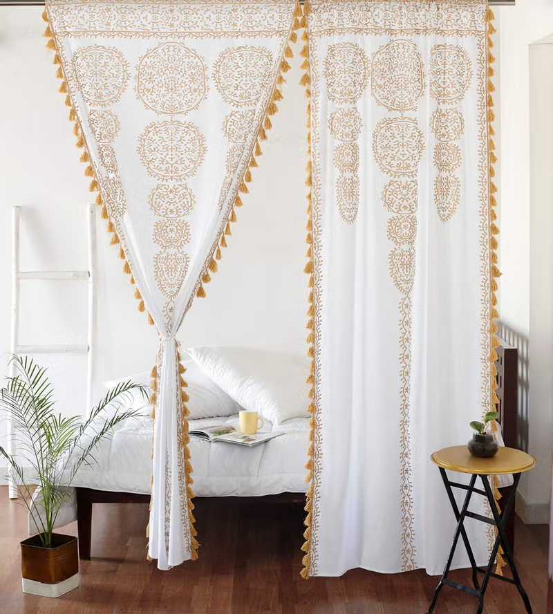 Two white and gold sheer cotton Indian mandala boho curtains with pom pom lace trim, 87 inches long by 41 inches wide