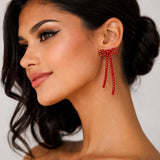 Silver bow-shaped clip-on dangle earrings with round clear CZ rhinestones on white background - view 6