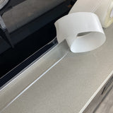 Clear self-adhesive PVC caulk strip tape 1.5 inch wide applied along bathtub and countertop seam edge - view 3