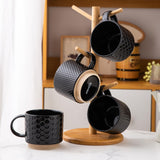 Set of 4 stackable black textured ceramic coffee mugs 12oz arranged in a stack on a white surface - view 8