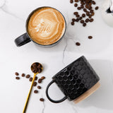 Set of 4 stackable black textured ceramic coffee mugs 12oz arranged in a stack on a white surface - view 3