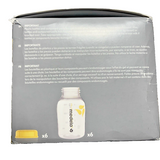Six Medela 5oz clear breast milk storage bottles with yellow lids showing ounce and milliliter measurement markers - view 2