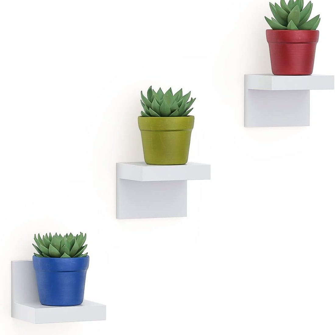 Three white L-shaped small floating wall shelves mounted on wall displaying small decor items, 4-inch plastic ledge set
