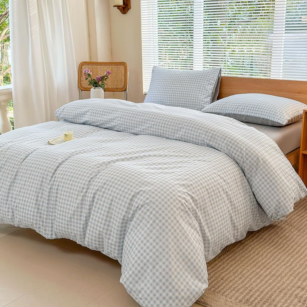Light blue gingham plaid Twin XL duvet cover set with matching pillow sham laid flat on a bed, 68x90 inches