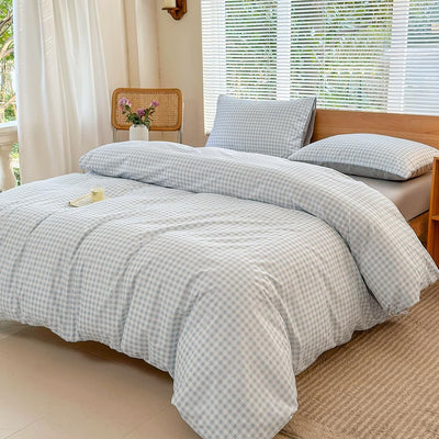 Light blue gingham plaid Twin XL duvet cover set with matching pillow sham laid flat on a bed, 68x90 inches