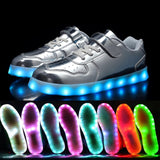 Silver kids LED light-up sneakers with hook and loop closure, size Big Kid 1, showing glowing sole lights - view 3